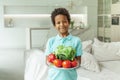 Cute child boy holding vegetables on white plate at home Royalty Free Stock Photo