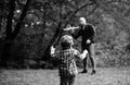 Cute child with dad play with toy plane. Father& x27;s day. Dad and baby son playing together outdoors toy airplane. Royalty Free Stock Photo