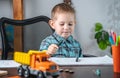 Cute child is drawing with pencils on paper in an album at the table. Preschool education and development of creativity Royalty Free Stock Photo
