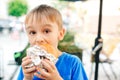 Cute child eating fast food. Childhood, unhealthy food concept. Junky food