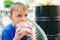 Cute child eating fast food. Childhood, unhealthy food concept. Junky food. Lifestyle and people