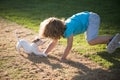 Cute child enjoying with her best friend dog. Funny doggy game. Kids playing with his pet dog. Royalty Free Stock Photo