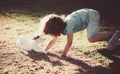 Cute child enjoying with her best friend dog. Funny doggy game. Kids playing with his pet dog. Royalty Free Stock Photo