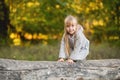 Cute child girl on all fours balances on a fallen log Royalty Free Stock Photo