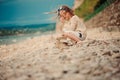Cute child girl building stone tower on the beach Royalty Free Stock Photo
