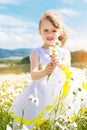 Cute child girl at camomile field Royalty Free Stock Photo