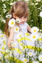 Cute child girl at camomile field Royalty Free Stock Photo