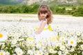 Cute child girl at camomile field Royalty Free Stock Photo