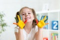 Cute child girl have fun coloring her hands Royalty Free Stock Photo