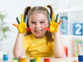 Cute child girl have fun painting her hands Royalty Free Stock Photo