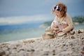 Cute child girl playing and building rock tower on summer beach Royalty Free Stock Photo