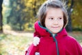 Cute child girl playing with fallen leaves in autumn Royalty Free Stock Photo