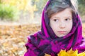 Cute child girl playing with fallen leaves in autumn Royalty Free Stock Photo
