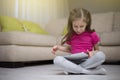 Cute child girl playing with a tablet computer. Royalty Free Stock Photo