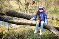 Cute child girl sitting on a tree branch Royalty Free Stock Photo