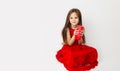 Cute child girl wearing elegant red dress with christmas candle isolated white background. Birthday celebration, Christmas, New Royalty Free Stock Photo