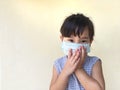 Cute child girl wearing a mask to prevent dust and germs.