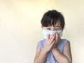 Cute child girl wearing a mask to prevent dust and germs.