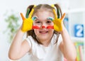 Cute child have fun painting her hands Royalty Free Stock Photo