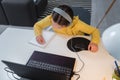 Cute child with headphones using laptop computer for online learning. Home school. Girl doing homework at home Royalty Free Stock Photo