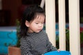 Cute child holding a blue bowl. Children use a plastic bowl to scoop water to water the plants.