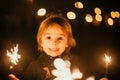 Cute child, holding sparkler at new year eve in garden Royalty Free Stock Photo