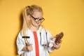 Cute child imagining herself as doctor while playing with reflex hammer and doll