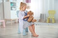 Cute child imagining herself as doctor while playing with stethoscope