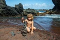 Cute child kid making pyramid of sea pebbles on beach. Life balance and harmony concept. Balancing nature. Little boy Royalty Free Stock Photo