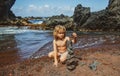 Cute child kid making pyramid of sea pebbles on beach. Life balance and harmony concept. Balancing nature. Little boy Royalty Free Stock Photo