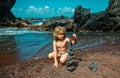 Cute child kid making pyramid of sea pebbles on beach. Life balance and harmony concept. Balancing nature. Little boy Royalty Free Stock Photo