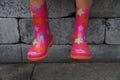 Cute child legs in rubber boots on a rainy day