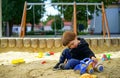 Child playing in the sandbox, kid having fun outdoor Royalty Free Stock Photo