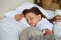 Cute child little girl sleeps in the bed with a toy elephant Royalty Free Stock Photo