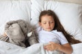 Cute child little girl sleeps in the bed with a toy elephant Royalty Free Stock Photo