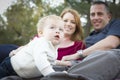 Cute Child Looks Up to Sky as Young Parents Smile Royalty Free Stock Photo