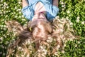 Cute child lying in daisy meadow Royalty Free Stock Photo