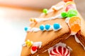 Cute, child-made gingerbread house, with imperfections a real gingerbread house assembly, for the Christmas holiday season, as a Royalty Free Stock Photo