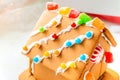 Cute, child-made gingerbread house, with imperfections a real gingerbread house assembly, for the Christmas holiday season, as a Royalty Free Stock Photo