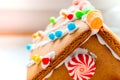 Cute, child-made gingerbread house, with imperfections a real gingerbread house assembly, for the Christmas holiday season, as a Royalty Free Stock Photo