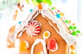 Cute, child-made gingerbread house, with imperfections a real gingerbread house assembly, for the Christmas holiday season, as a Royalty Free Stock Photo