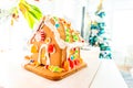 Cute, child-made gingerbread house, with imperfections a real gingerbread house assembly, for the Christmas holiday season, as a Royalty Free Stock Photo