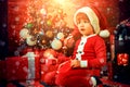 Cute child opening christmas gift. Lovely baby enjoy christmas. Santa boy little child winter celebrate at home. Boy Royalty Free Stock Photo