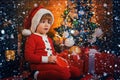 Cute child opening christmas gift. Lovely baby enjoy christmas. Santa boy little child winter celebrate at home. Boy Royalty Free Stock Photo