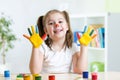 Cute child painting her hands