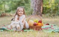 Cute child on picnic with basket, Toddler kid having a rest in sunny park or garden. Little girl with teddy and enjoying Royalty Free Stock Photo