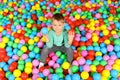 Cute child playing in ball pit Royalty Free Stock Photo