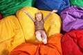 Cute child playing on colorful bean bag chairs