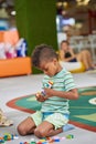 Cute child playing with constructor in play room. Royalty Free Stock Photo