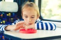 Cute child playing popit toy during travelling by train. Entertainment for young passenger Royalty Free Stock Photo
